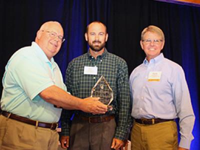 Gas Distribution Engineers Carl Smith (center) and Durk Tyson (right) receiving the award.