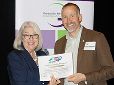 Water Quality Manager Anthony Whitehead accepts award from Cherie Berry, NC Commissioner of Labor