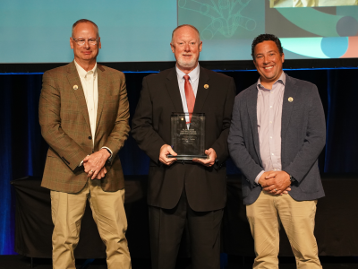 General Manager/CEO Tony Cannon, center, receives the Alex Radin Distinguished Service Award
