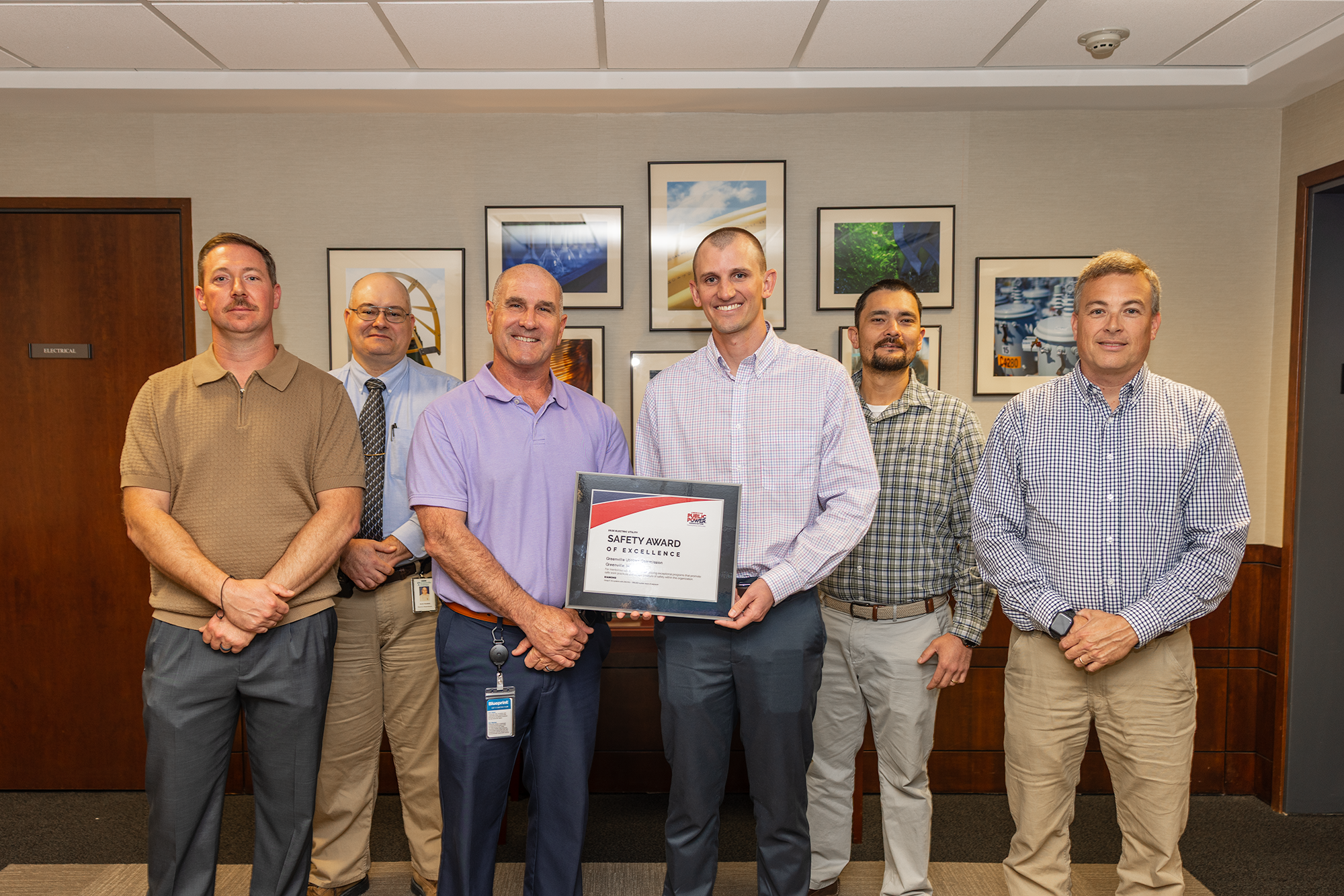Electric engineers pose with safety award