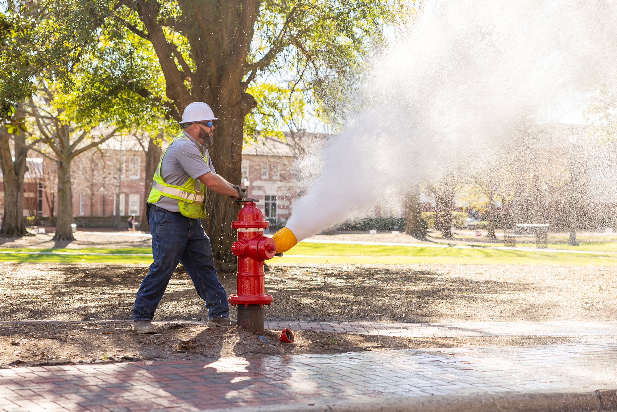 GUC worker flushes fire hydrant